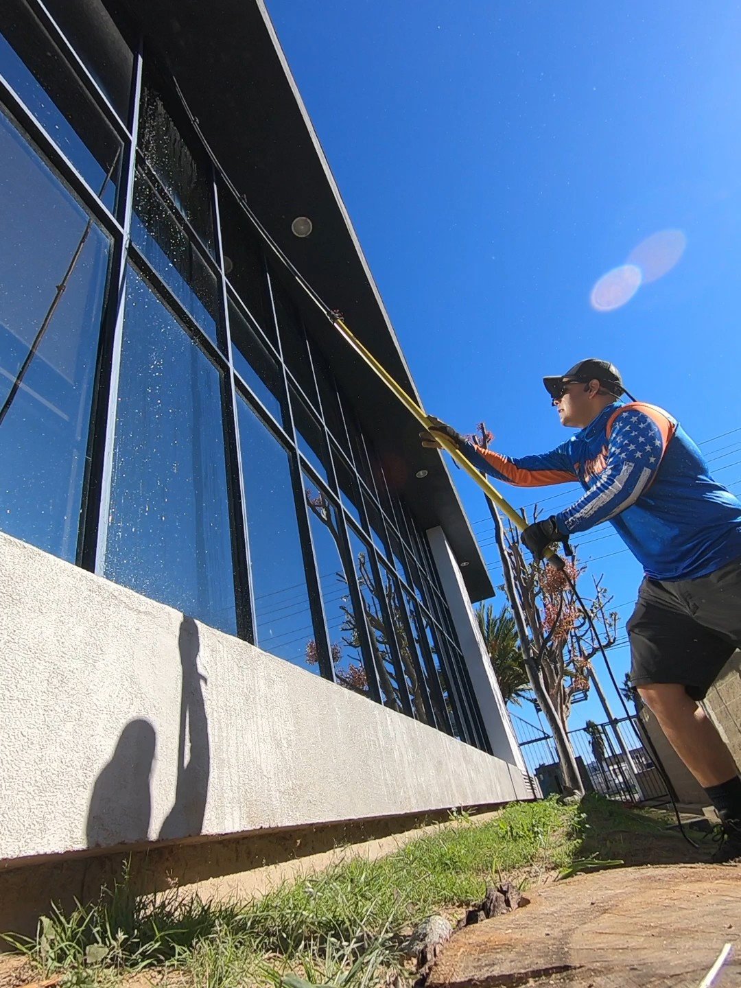 Cleaning commercial windows with a water fed pole